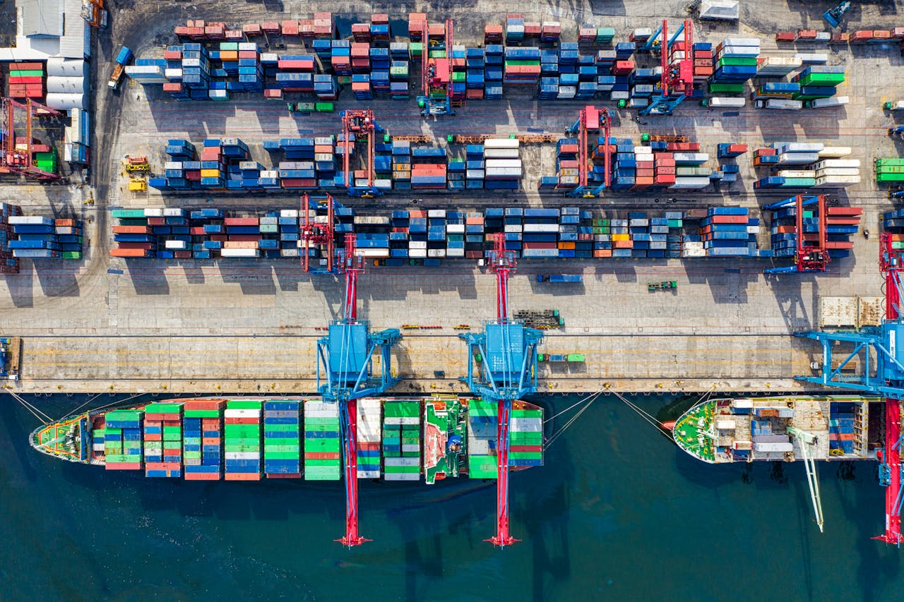 Services Drone shot capturing vibrant container ships and dock in North Jakarta port, Indonesia.